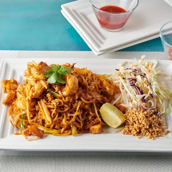 Blue Mango's Pad Thai with chicken, shrimp, lime, crushed peanuts, and shredded cabbage.
